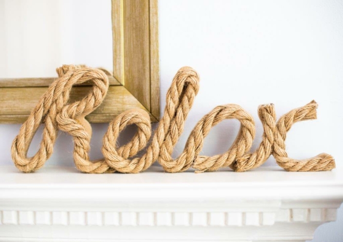 The word relax made out of rope on a mantlepiece